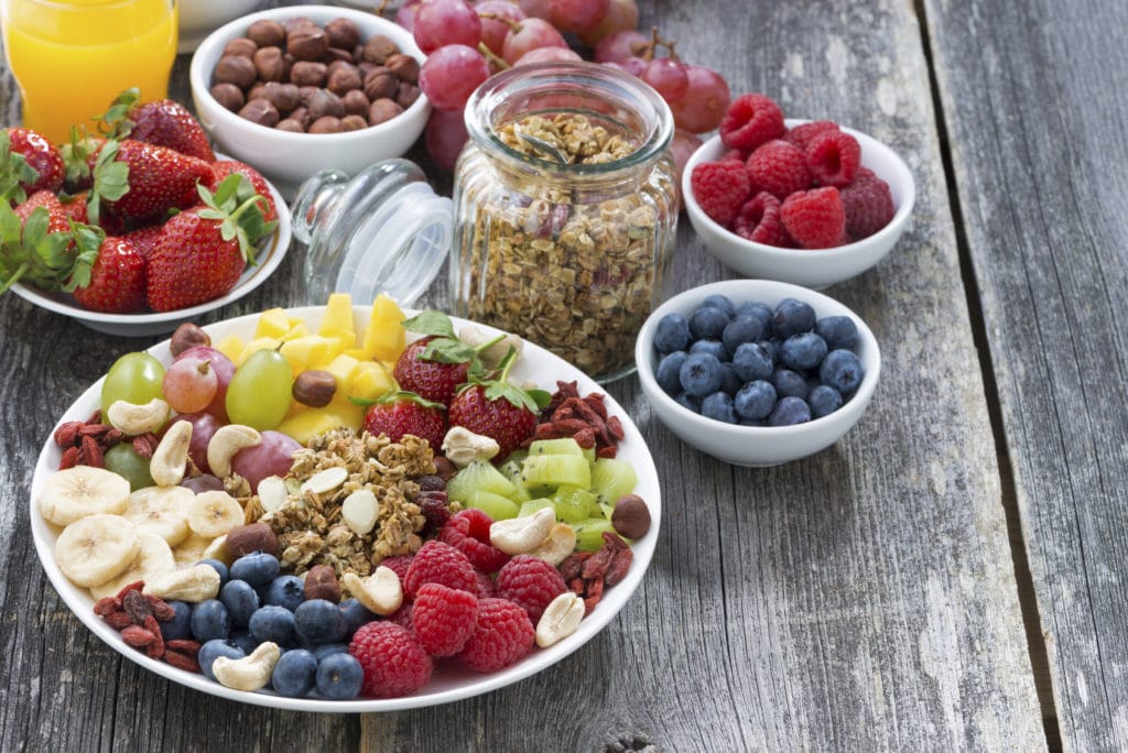 ingredients for a healthy breakfast - berries, fruit, muesli